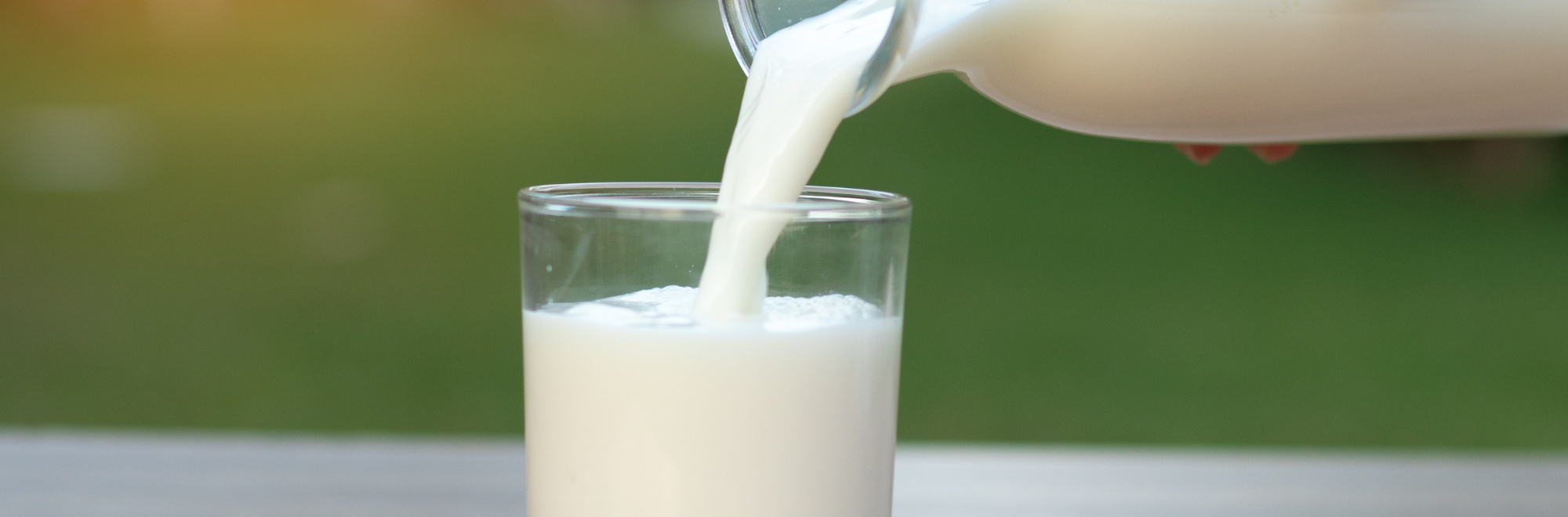 bottle of milk pouring into a glass