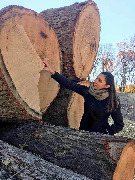 Laura Cisneros poses near a felled tree.