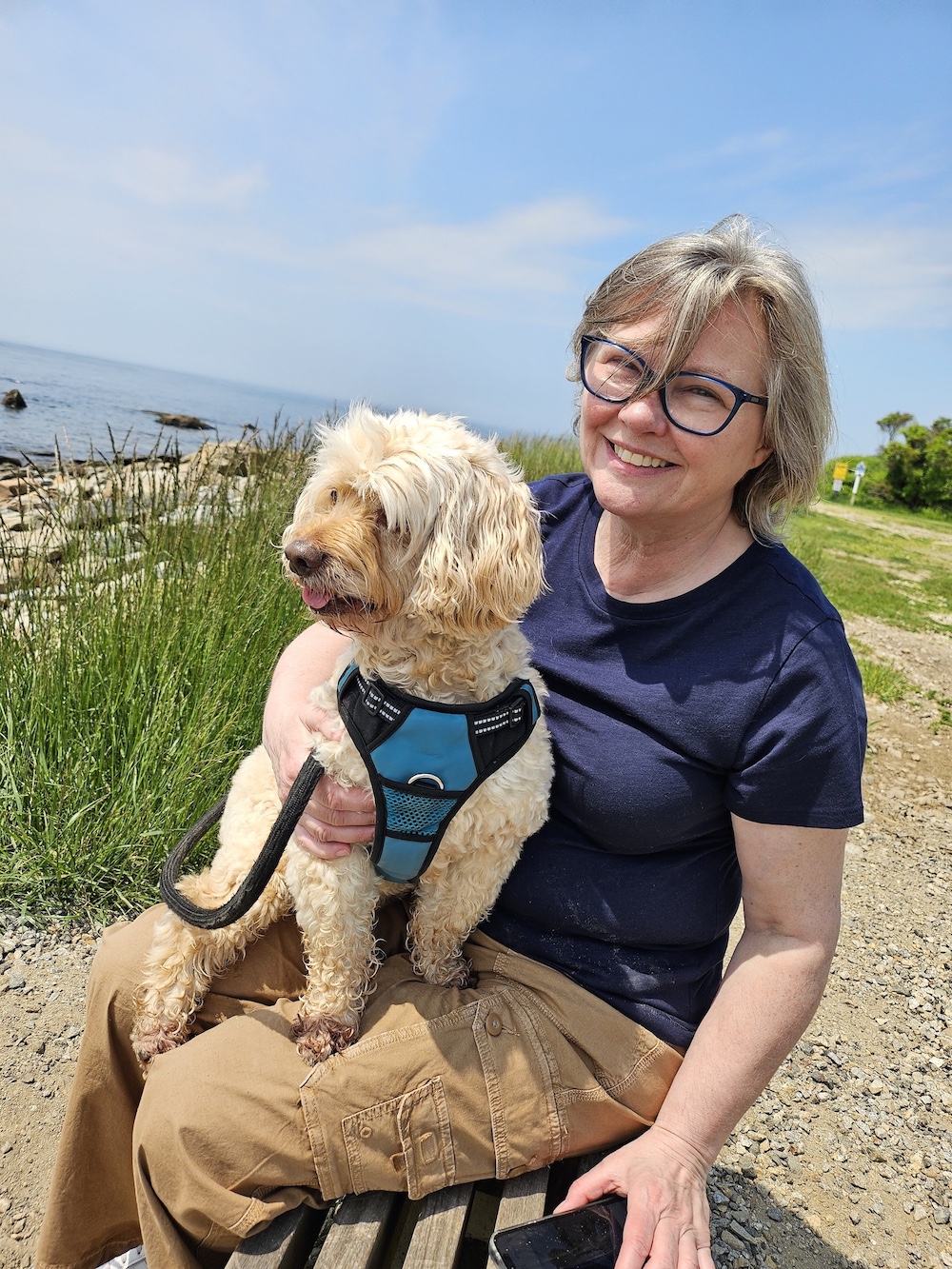 portrait of Joanna Woodward sitting at a state park with her dog