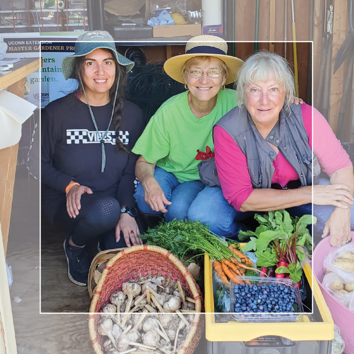 Master Gardener volunteers pose with fresh vegetables