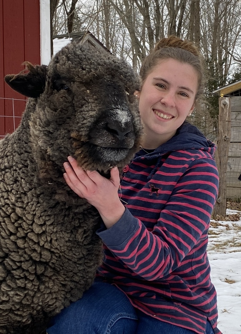 Sara Tomis with a sheep