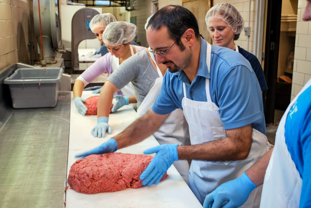 professor and students in the meat lab