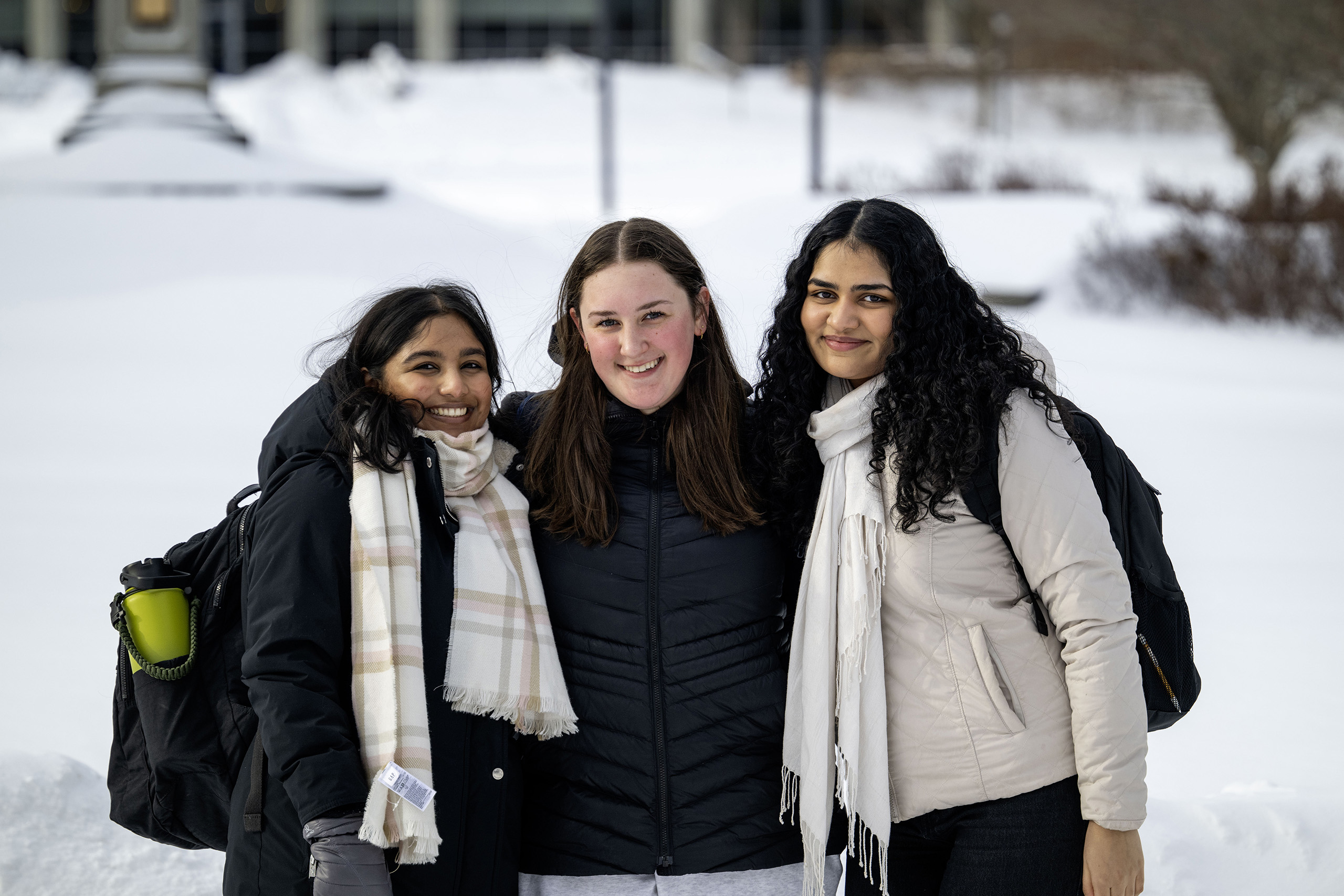 Three students posing in the snow